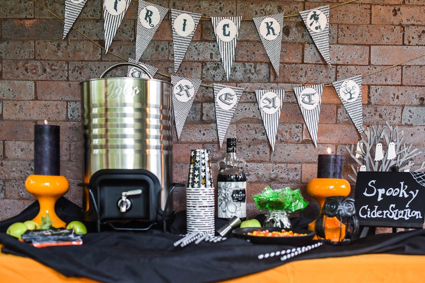 Up Your Trick or Treating Game with a Spooky Front Porch Cider Station